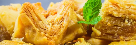 Jewish, turkish, arabic traditional national dessert. Macro. Selective focus. Baklava with honey and nutsの写真素材