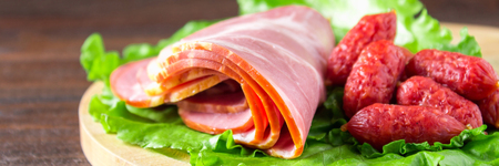 Assorted meat products including ham and sausages.の写真素材