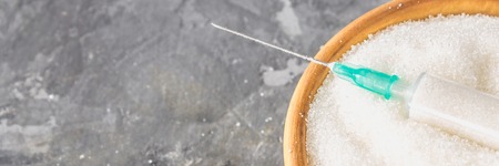 Sugar in a syringe. Conceptual depiction of dependence on the sweet. Sugar is a drug. Injection of sweets.の写真素材
