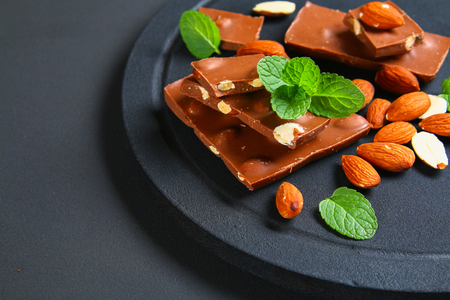 chocolate with almonds on dark grey backgroundの写真素材