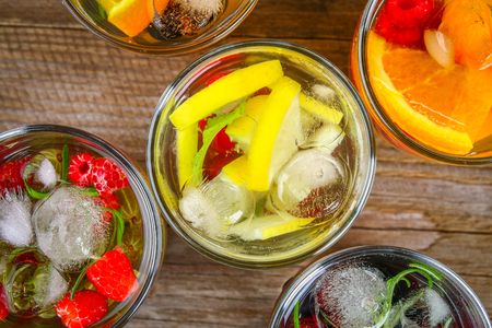 Various detox water in glasses, different tastes, berries, fruitsの写真素材