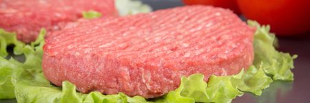 Raw burgers with lettuce on a gray background. Tomatoes, peppers chilliの写真素材