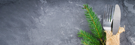 Fork with a knife in the sacking on a gray background.の写真素材