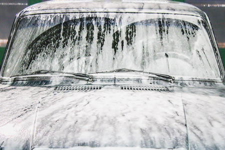 Man washes foam machine. Carwash. Washing machine at the stationの写真素材