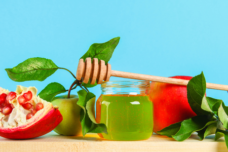 Rosh hashanah jewish New Year holiday concept. Traditional symbol. Apples, honey, pomegranateの写真素材