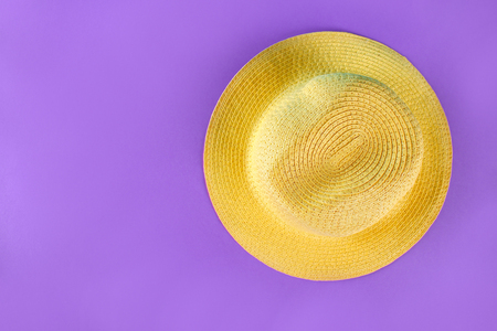 Yellow summer hat on a purple backgroundの写真素材