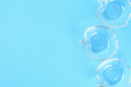 Glass cups for honey in the form of apples on a pastel of blue background. Rosh Hashanahの写真素材