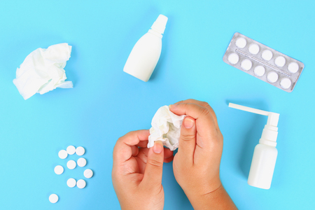 Medicines for flu, illness, cold, cough against a blue table with tablets. Top view, copy space, flat layの写真素材