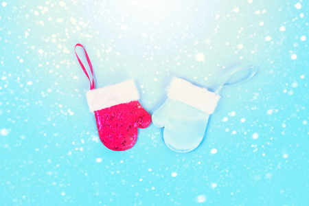 Winter cap and mitten on a blue background. Top view, flat layの写真素材