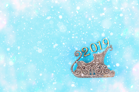 Text 2019 year. Sledge, team on a blue background. Top view, flat lay