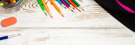 School supplies on a white wooden background with an empty space for inscriptions