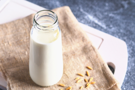 Oatmeal in a glass bottle. Oat grain and cereal in jarsの写真素材