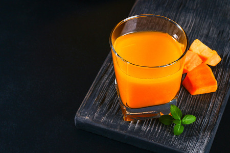 Pumpkin Smoothie Pumpkin juice on a dark table. Autumn drinksの写真素材