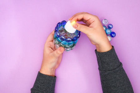 How to make your own candlestick from unnecessary glass or plastic and glass pebbles. Step by step....