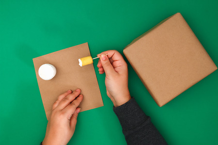 The original design of a Christmas gift of craft paper, white paint, a stamp of potatoes.の写真素材