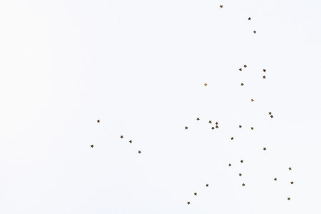 Christmas layout. Golden confetti in the form of stars on a white background. New Year 2019, christmas, winter concept. Copy space, tov view, flat lay compositionの写真素材