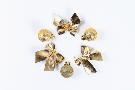 Christmas layout. Golden toy ball, bow on a white background. New Year 2019, christmas, winter concept. Copy space, tov view, flat lay compositionの写真素材