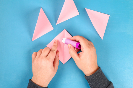 DIY Valentines greeting card blue wooden background. Gift ideas day love, February 14, Valentines Day. Handmade. Card volumetric heart paper form balloon, box. Step by step. process crafts. Top viewの写真素材