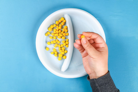 Diy greeting card with mimosa flowers paper balls for March 8 on blue background. Gift idea, decor International Womens Day, March 8, Mother day. Step by step. Top view. Process kid childrens craft.の写真素材