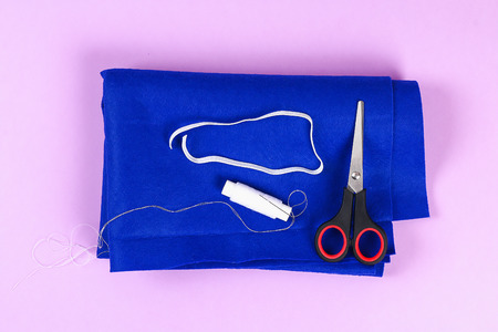 Diy blue felt sleep mask with white thread embroidered with closed eyes with eyelashes on gum on...