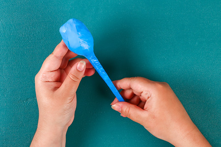 Diy cinco de mayo maracas from eggs, spoons and cereals on a green background. Gift idea, decor cinco de mayo. Step by step. Top view. Process kid children craft.の写真素材