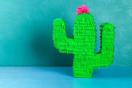 Diy cinco de mayo Mexican Pinata Cactus made cardboard and crepe paper your own hands on a blue background. Gift idea, decor, game cinco de mayo. Step by step. Top view. Process kid children craft.の写真素材