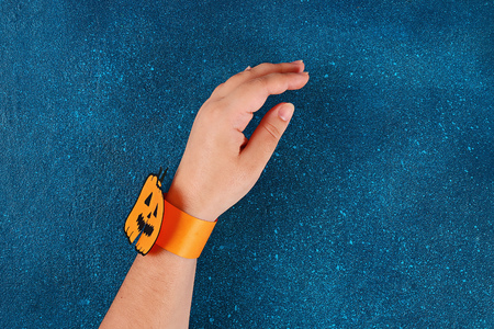 Diy Halloween paper bracelet pumpkin on black background. Gift idea, decor Halloween. Step by step....