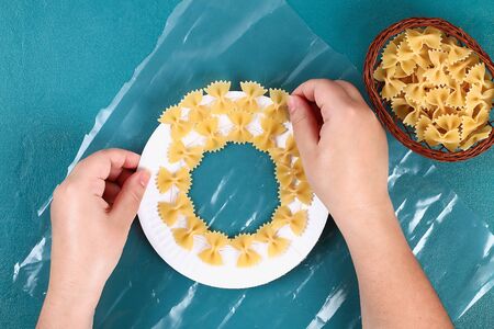 Diy Christmas pasta wreath on blueの写真素材