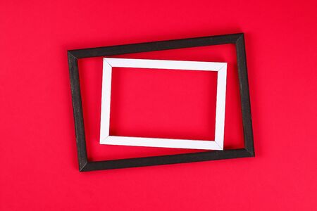Summer ideas concept with tropical leaf white and black frame border with on red burgundy paperの写真素材