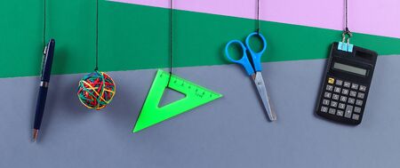 School supplies hang on the rope. School supplies on grey background. Back to school concept. bannerの写真素材