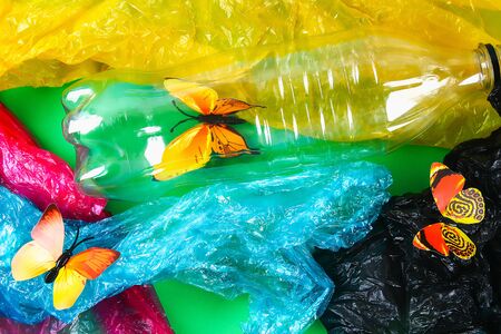 Plastic pollution in environmental problem of nature. Butterflies in plastic bottles, packages. Ecological situation in the world earth. Pollution of nature. Zero waste.の写真素材