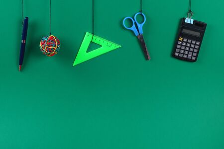 School supplies hang on the rope. School supplies on green background. Back to school conceptの写真素材