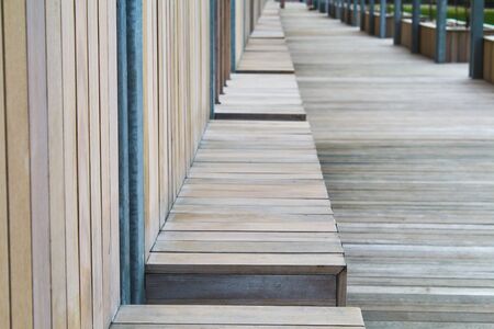 Street wooden bench in perspective, bench in the park. Wooden wall.