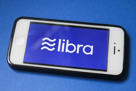 Libra Facebook cryptocurrency on screen mobile Iphone. Bitcoin cryptocurrency. Libra coins concept. Stavropol, June 2019のeditorial素材