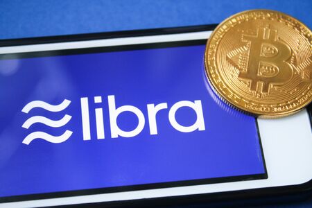 Libra Facebook cryptocurrency on screen mobile Iphone. Bitcoin cryptocurrency. Libra coins concept....