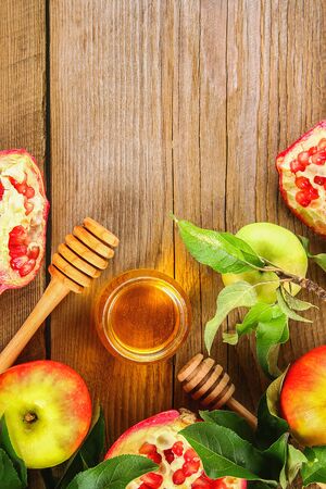 Rosh hashanah jewish New Year holiday concept. Traditional symbol. Apples, honey, pomegranate. Copy space. Top view. Flat layの写真素材