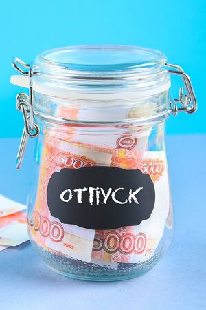 Bank with Russian money, 5000 rubles and a calculator on a gray background. Finance, moneybox,...