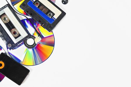 The concept of the evolution of music. Cassette, CD-disk, mp3 player on white background. Vintage...