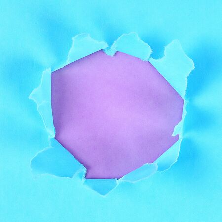Torn color wrapped paper with space for your message. Hole ripped in paper on background. Copy spaceの写真素材