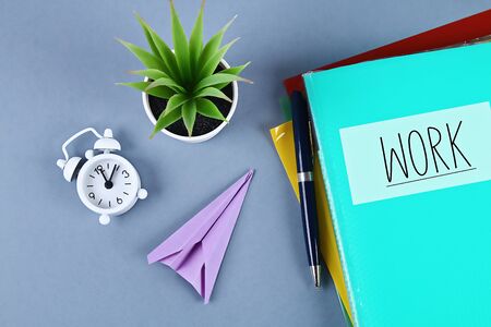 Procrastination, delay and urgency concept. Putting off work to be done. Replacing the work of folding aircraft.の写真素材