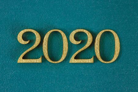 Happy New Year 2020. Creative text Happy New Year 2020 written in gold wooden letters. Merry...