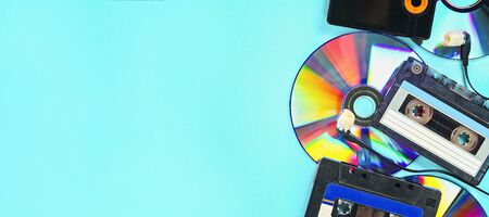 The concept of the evolution of music. Cassette, CD-disk, mp3 player on blue background. Vintage and modernity. Music support. Bannerの写真素材