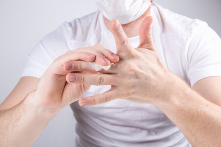 A man cleans hands with wet antibacterial wipes. Virus protection.