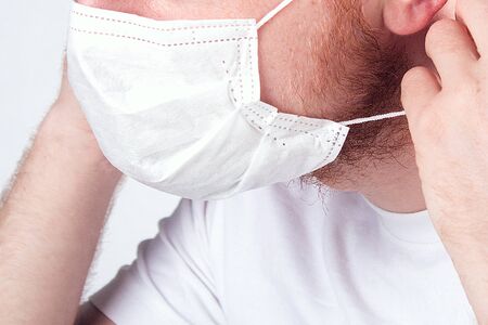 A man wearing a protective mask against coronavirus. Banner panorama. Epidemic, pandemic,...