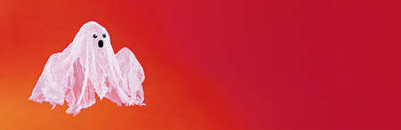 Diy Halloween ghost of starch and gauze on orange background. Gift idea, decor Halloween. kid...
