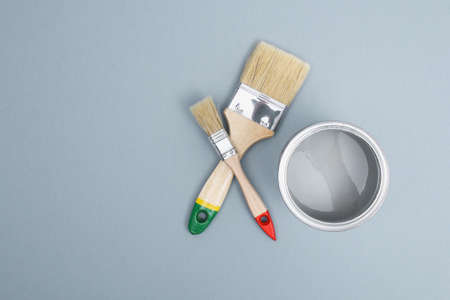 Open paint enamel cans on gray palette samples. The concept of repair, construction.の写真素材