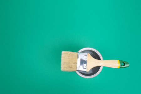 Open paint enamel cans on color palette samples. The concept of repair, construction. Shades of turquoise green.の写真素材