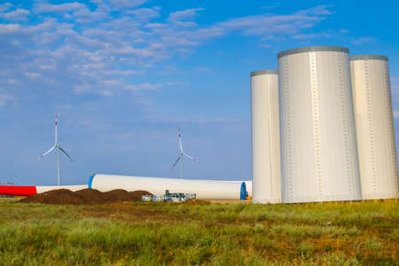 Windmill construction. Installation of a wind turbine. Blue sky.