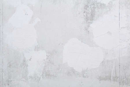 Gray concrete wall peeled of wallpaper. Concrete background.