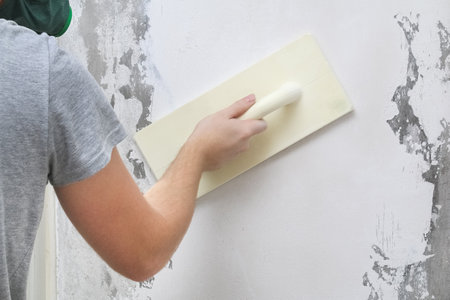 Male working polishes grinds wall. Plastering Float Trowel.の写真素材